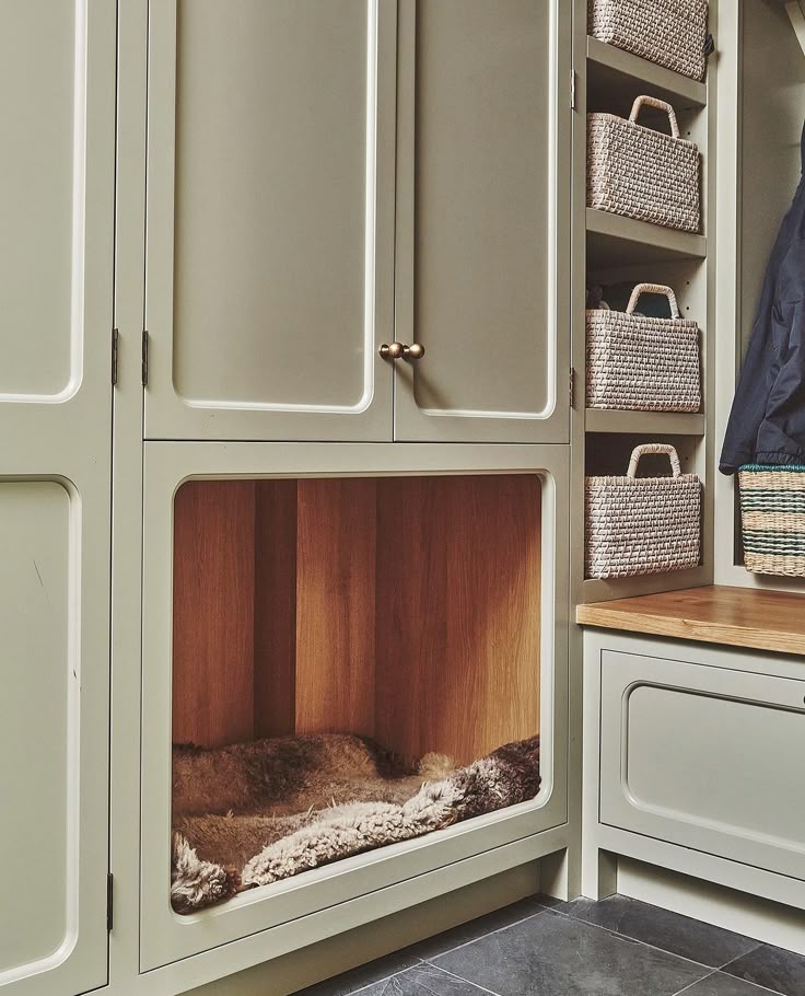 Stylish woven baskets and labeled storage bins neatly organized in a mudroom, providing an elegant solution for storing pet toys, leashes, and grooming supplies without compromising on design.